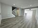 Spacious living room featuring modern wood flooring, neutral walls and staircase at 6174 Meadowgrass Ln, Las Vegas, NV 89103