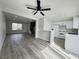 Open-concept living space with modern flooring flowing into the kitchen at 6174 Meadowgrass Ln, Las Vegas, NV 89103