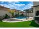 Resort-style backyard with pool, spa, and lush turf, ideal for relaxation and recreation at 6655 Tranquil Seas Ct, Las Vegas, NV 89139