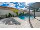 Custom backyard boasts a beautiful pool, waterfall feature, and cozy fire pit at 6655 Tranquil Seas Ct, Las Vegas, NV 89139