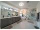 Luxurious bathroom featuring double vanities, marble accents, modern fixtures, soaking tub and glass shower at 6655 Tranquil Seas Ct, Las Vegas, NV 89139