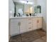 Bright bathroom featuring a modern double vanity with gold hardware and sleek fixtures at 6655 Tranquil Seas Ct, Las Vegas, NV 89139