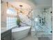 Modern bathroom with a glass shower, soaking tub, stylish lighting, and luxurious finishes at 6655 Tranquil Seas Ct, Las Vegas, NV 89139