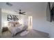 A spacious bedroom with a ceiling fan, carpet, and modern design at 6655 Tranquil Seas Ct, Las Vegas, NV 89139