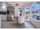 Eat-in breakfast nook with stainless steel refrigerator, modern chandelier, and views of the private backyard at 6655 Tranquil Seas Ct, Las Vegas, NV 89139