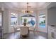 Breakfast nook with backyard views of the pool and rock feature, modern lighting, and comfortable seating at 6655 Tranquil Seas Ct, Las Vegas, NV 89139