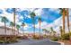 Gated community entrance lined with towering palm trees and well-maintained landscaping under a blue sky at 6655 Tranquil Seas Ct, Las Vegas, NV 89139