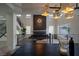 Open dining area with views of the stairwell and living room with fireplace at 6655 Tranquil Seas Ct, Las Vegas, NV 89139