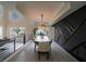 Elegant dining room with modern chandelier, tray ceiling, and custom wall design at 6655 Tranquil Seas Ct, Las Vegas, NV 89139
