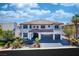 Beautiful two-story home featuring a well-manicured front yard and an attached two-car garage at 6655 Tranquil Seas Ct, Las Vegas, NV 89139