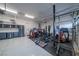 Well-equipped home gym with weightlifting equipment, storage cabinets, and durable flooring at 6655 Tranquil Seas Ct, Las Vegas, NV 89139