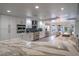 Modern kitchen featuring white cabinetry, stainless steel appliances, a marble countertop, and recessed lighting at 6655 Tranquil Seas Ct, Las Vegas, NV 89139