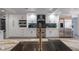 Modern kitchen with stainless steel appliances, white cabinetry, and a large island with marble countertops at 6655 Tranquil Seas Ct, Las Vegas, NV 89139