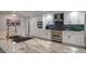 Bright kitchen with modern appliances, white cabinetry, stylish backsplash, and spacious marble countertop island at 6655 Tranquil Seas Ct, Las Vegas, NV 89139