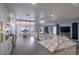 Open-concept kitchen featuring white cabinets, marble countertops, stainless steel appliances, and an eat-in breakfast nook at 6655 Tranquil Seas Ct, Las Vegas, NV 89139