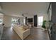 Bright living room with modern fireplace, large windows, and sliding glass door to outdoor patio at 6655 Tranquil Seas Ct, Las Vegas, NV 89139