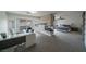 Spacious primary bedroom with fireplace, work space, ceiling fan, and sliding door to the outdoor deck at 6655 Tranquil Seas Ct, Las Vegas, NV 89139