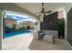 Inviting outdoor seating area with a modern sectional sofa and a view of the backyard pool and water feature at 6655 Tranquil Seas Ct, Las Vegas, NV 89139