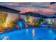 Backyard pool with rock waterfall and fire features, creating a tranquil outdoor oasis at 6655 Tranquil Seas Ct, Las Vegas, NV 89139