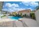 Backyard swimming pool with a rock waterfall feature, a spa, and a paved patio area at 6655 Tranquil Seas Ct, Las Vegas, NV 89139