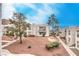 Low angle view of the exterior of the condominium complex with desert landscaping and sidewalks at 6800 E Lake Mead Blvd # 2107, Las Vegas, NV 89156