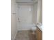 Tiled tub and shower with neutral walls, and coordinating tiled floor in bathroom at 6955 N Durango Dr # 2107, Las Vegas, NV 89149