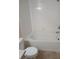 Tiled tub and shower with neutral walls and coordinating floor in bathroom at 6955 N Durango Dr # 2107, Las Vegas, NV 89149
