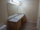 Bright bathroom featuring a double sink vanity with modern fixtures and tile flooring at 6955 N Durango Dr # 2107, Las Vegas, NV 89149
