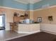 The community common area includes a full kitchen, counter seating, and room to sit and relax at 6955 N Durango Dr # 2107, Las Vegas, NV 89149