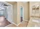 Bathroom featuring tile floors, a sink with granite countertops, and an attached room beyond the doorway at 7255 W Sunset Rd # 1090, Las Vegas, NV 89113