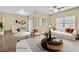 Bright, staged living room featuring neutral tones, large windows, and an adjacent dining area at 7255 W Sunset Rd # 1090, Las Vegas, NV 89113