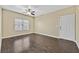 Inviting living room featuring ceiling fan, wood floors, and a front door entrance at 7255 W Sunset Rd # 1090, Las Vegas, NV 89113