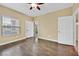 Inviting bedroom space featuring a ceiling fan, hardwood floors, and natural light from the window at 7255 W Sunset Rd # 1090, Las Vegas, NV 89113