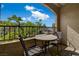 Cozy balcony area furnished with a table and two chairs, offering serene outdoor space with natural views at 7885 W Flamingo Rd # 2012, Las Vegas, NV 89147