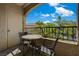 Cozy balcony area furnished with a table and two chairs, offering serene outdoor space with natural views at 7885 W Flamingo Rd # 2012, Las Vegas, NV 89147