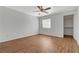 A bright, spacious bedroom with wood-look flooring, a ceiling fan, and natural light from the window at 7885 W Flamingo Rd # 2012, Las Vegas, NV 89147