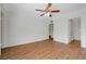 A bright, spacious bedroom with wood-look flooring, a ceiling fan, and natural light from the window at 7885 W Flamingo Rd # 2012, Las Vegas, NV 89147