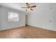 A bright, spacious bedroom with wood-look flooring, a ceiling fan, and natural light from the window at 7885 W Flamingo Rd # 2012, Las Vegas, NV 89147