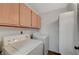 A bright laundry area equipped with a washer, a dryer, and overhead cabinets for storage solutions at 7885 W Flamingo Rd # 2012, Las Vegas, NV 89147