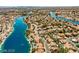Extensive aerial shot showcases a community filled with homes surrounding the expansive lake system at 8433 Honeywood Cir, Las Vegas, NV 89128