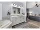 Bright bathroom boasting a soaking tub, double sinks, and access to the main bedroom at 8433 Honeywood Cir, Las Vegas, NV 89128