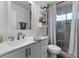 Modern bathroom features white cabinetry, a sleek countertop, and a glass-enclosed walk-in shower at 8433 Honeywood Cir, Las Vegas, NV 89128