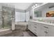 Bright, modern bathroom featuring a glass-enclosed shower, soaking tub, and double vanity at 8433 Honeywood Cir, Las Vegas, NV 89128