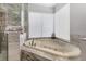 Close up on a soaking tub featuring tile surround and jacuzzi jets at 8433 Honeywood Cir, Las Vegas, NV 89128