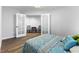Bright bedroom features a comfortable bed, wood floors, and French doors that provide access to another room at 8433 Honeywood Cir, Las Vegas, NV 89128