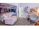 Bedroom features a plush chair and an open closet with shelving at 8433 Honeywood Cir, Las Vegas, NV 89128
