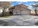 Charming two-story home featuring a well-maintained front yard, and a wide driveway to the garage at 8433 Honeywood Cir, Las Vegas, NV 89128