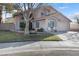 Charming two-story home featuring a well-maintained front yard with mature landscaping and a wide driveway at 8433 Honeywood Cir, Las Vegas, NV 89128