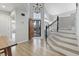 Elegant foyer with wood floors, a staircase and ample natural light streaming through the large windows at 8433 Honeywood Cir, Las Vegas, NV 89128