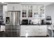Spacious kitchen with stainless steel refrigerator and glass-front cabinets providing ample storage and style at 8433 Honeywood Cir, Las Vegas, NV 89128